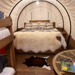 Tall Texan RV Park Glamping Gunnison Colorado interior of cover wagon glamping structure