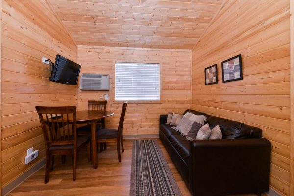Dining and family room area in our 2-bedroom cabin (sofa folds out to sleep 2) at Gunnison Lakeside RV Park and Cabins in Color